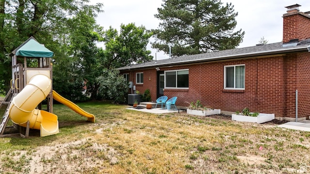 1820 E Meadow Dr S, Cottonwood Heights, UT 84121 - back of property featuring a yard, a playground, brick siding, and a chimney