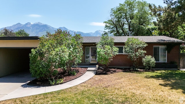 1820 E Meadow Dr S, Cottonwood Heights, UT 84121 - view of front of house with a front lawn, brick siding, a mountain view, and a shingled roof