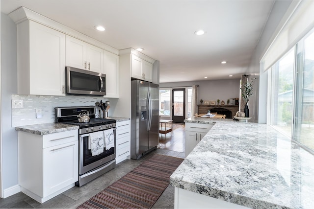 1820 E Meadow Dr S, Cottonwood Heights, UT 84121 - kitchen with stainless steel appliances, tasteful backsplash, white cabinetry, recessed lighting, and light stone countertops