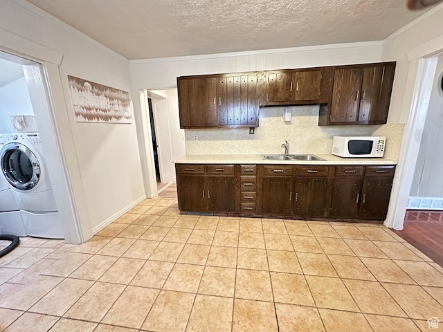 841 E Markea Ave, Salt Lake City, UT 84102 - kitchen with white microwave, a sink, light countertops, decorative backsplash, and dark brown cabinets