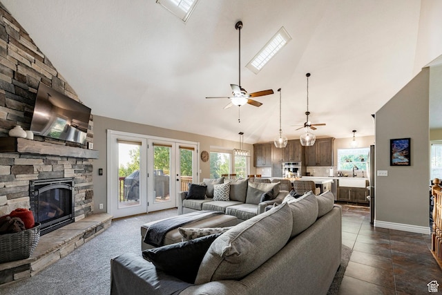 13898 Summerset Cir, Draper, UT 84020 - living room featuring a fireplace, high vaulted ceiling, plenty of natural light, a ceiling fan, and baseboards