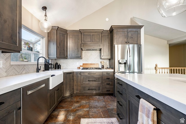 13898 Summerset Cir, Draper, UT 84020 - kitchen featuring appliances with stainless steel finishes, vaulted ceiling, tasteful backsplash, dark brown cabinets, and hanging light fixtures