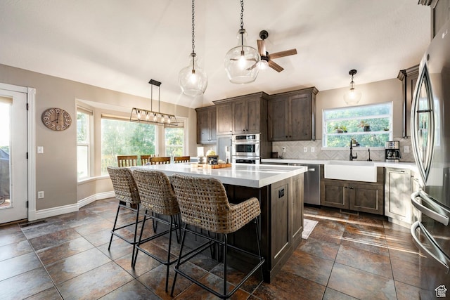 13898 Summerset Cir, Draper, UT 84020 - kitchen with a sink, stainless steel appliances, healthy amount of natural light, backsplash, and lofted ceiling