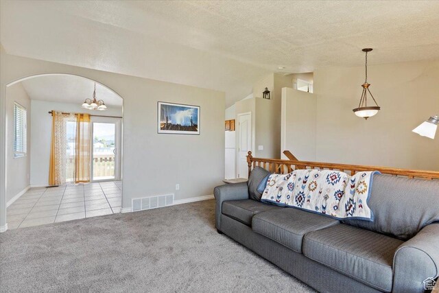 2373 S 2830 W, Syracuse, UT 84075 - carpeted living room featuring vaulted ceiling, baseboards, a chandelier, a textured ceiling, and tile patterned flooring