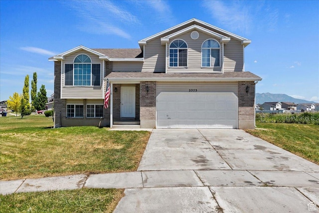 2373 S 2830 W, Syracuse, UT 84075 - view of front of property featuring a front lawn, an attached garage, concrete driveway, and brick siding