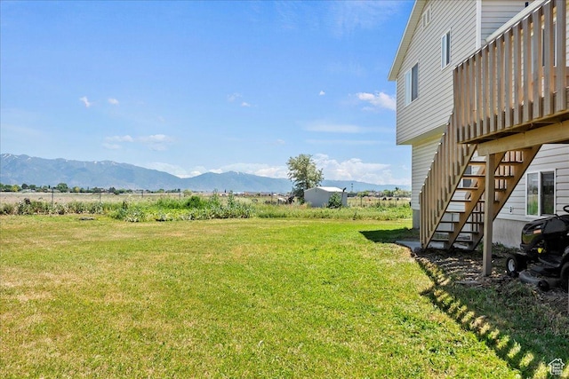 2373 S 2830 W, Syracuse, UT 84075 - view of green lawn featuring stairway, a deck with mountain view, and a rural view