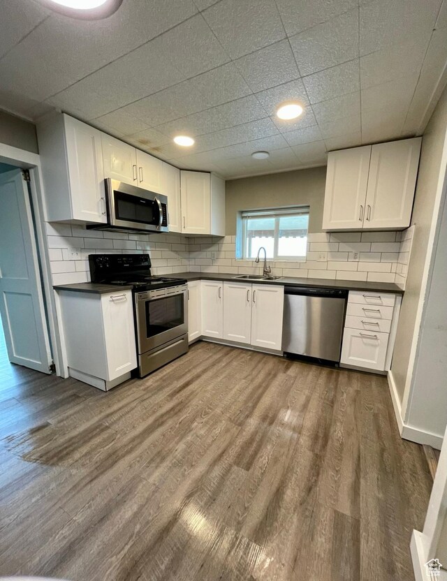 947 W 1300 N, Carbonville, UT 84501 - kitchen featuring stainless steel appliances, dark countertops, a sink, and white cabinetry