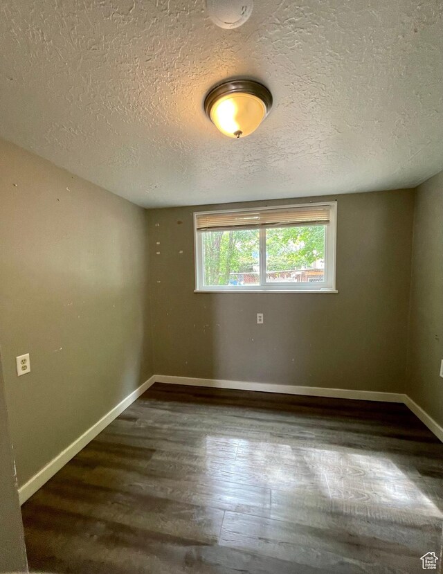 947 W 1300 N, Carbonville, UT 84501 - empty room featuring wood finished floors, a textured ceiling, and baseboards