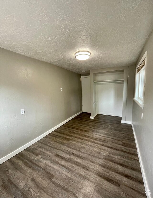 947 W 1300 N, Carbonville, UT 84501 - unfurnished bedroom with wood finished floors, a textured ceiling, baseboards, and a closet