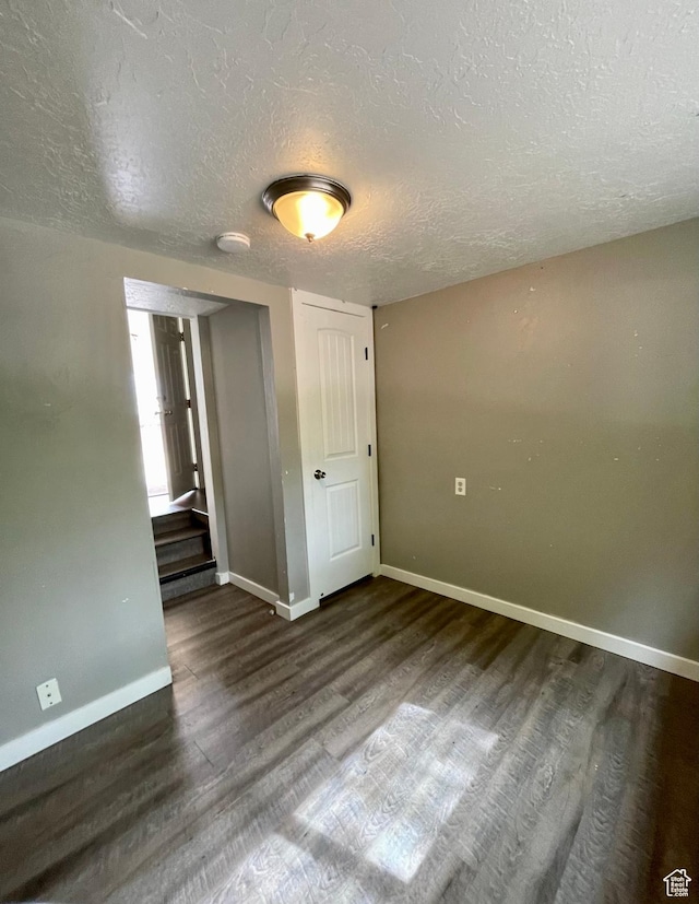 947 W 1300 N, Carbonville, UT 84501 - unfurnished bedroom with baseboards, a textured ceiling, and wood finished floors