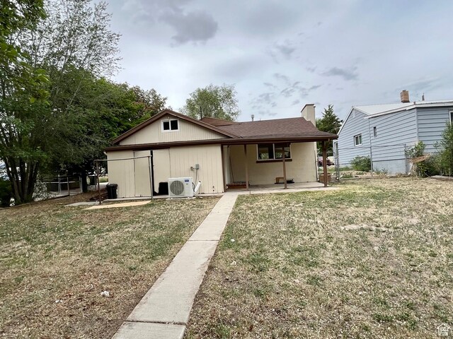 947 W 1300 N, Carbonville, UT 84501 - back of house with a cooling unit, a yard, and covered porch