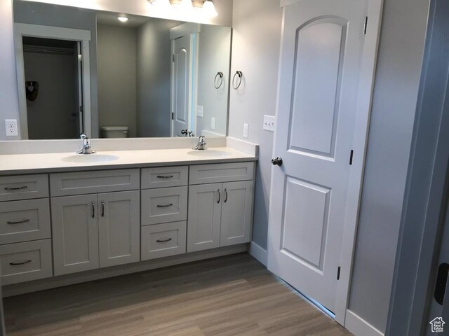 1515 N 250 E, Nephi, UT 84648 - full bathroom with double vanity, wood finished floors, toilet, and baseboards