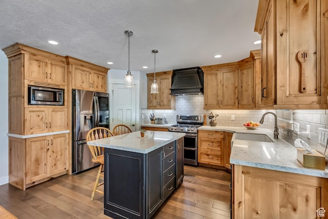 849 N 400 E, Springville, UT 84663 - kitchen with appliances with stainless steel finishes, custom exhaust hood, a sink, wood-type flooring, and light stone counters
