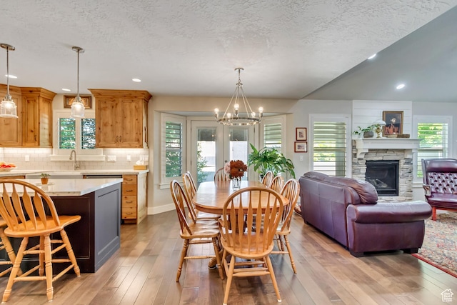849 N 400 E, Springville, UT 84663 - dining area with a chandelier, light wood-type flooring, a fireplace, a textured ceiling, and recessed lighting