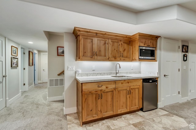 849 N 400 E, Springville, UT 84663 - kitchen with a sink, stainless steel microwave, light countertops, light carpet, and brown cabinetry
