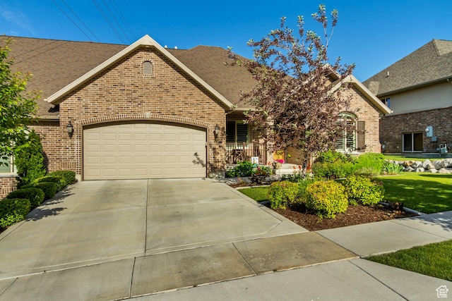 849 N 400 E, Springville, UT 84663 - view of front of property featuring brick siding, a garage, concrete driveway, a shingled roof, and a front yard
