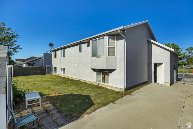 4564 S Early Duke St, West Valley City, UT 84120 - rear view of property with a patio, stucco siding, and a gate