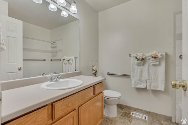 4564 S Early Duke St, West Valley City, UT 84120 - bathroom featuring vanity, toilet, a shower, and baseboards