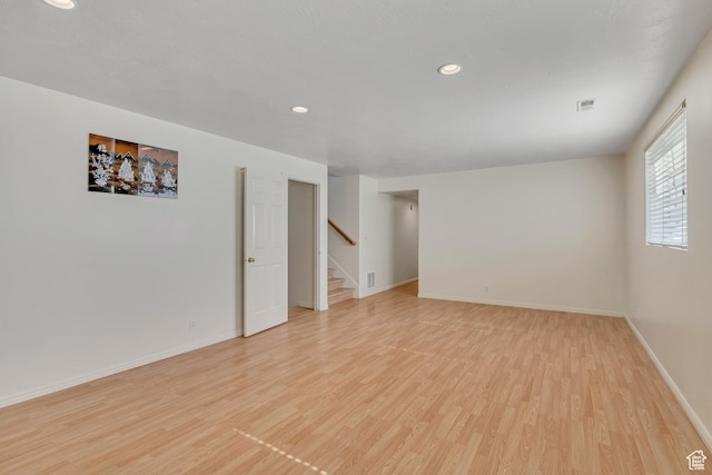 4564 S Early Duke St, West Valley City, UT 84120 - unfurnished room featuring light wood-style flooring, baseboards, recessed lighting, and stairs