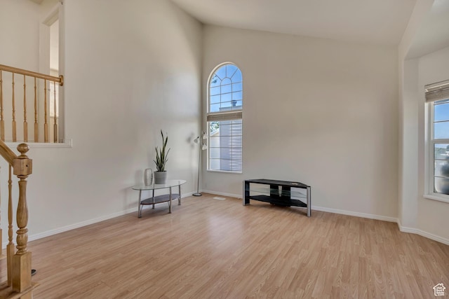 4564 S Early Duke St, West Valley City, UT 84120 - empty room with light wood-style floors, healthy amount of natural light, baseboards, and a towering ceiling