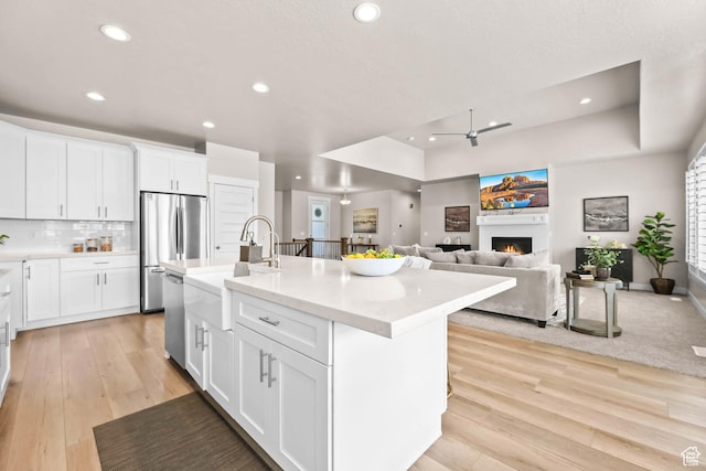 9447 N Arrowhead Dr, Eagle Mountain, UT 84005 - kitchen with a sink, a raised ceiling, appliances with stainless steel finishes, recessed lighting, and ceiling fan