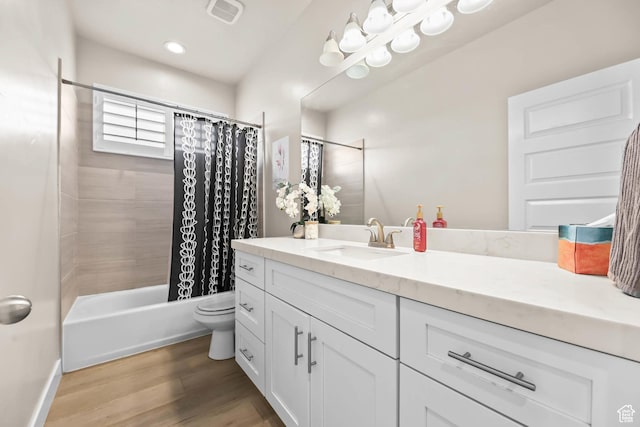 9447 N Arrowhead Dr, Eagle Mountain, UT 84005 - bathroom featuring vanity, toilet, shower / bath combo with shower curtain, wood finished floors, and baseboards