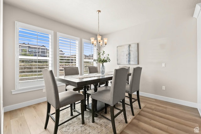 9447 N Arrowhead Dr, Eagle Mountain, UT 84005 - dining space with a chandelier, baseboards, and light wood-style floors
