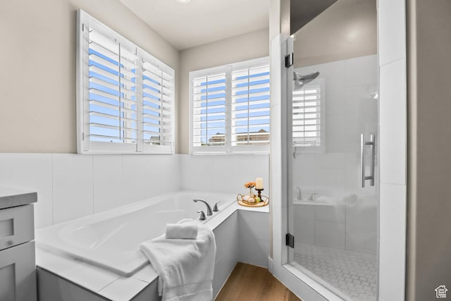 9447 N Arrowhead Dr, Eagle Mountain, UT 84005 - bathroom with a stall shower, a garden tub, and wood finished floors