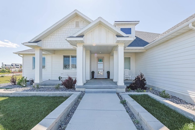 9447 N Arrowhead Dr, Eagle Mountain, UT 84005 - property entrance featuring a porch, board and batten siding, and a shingled roof