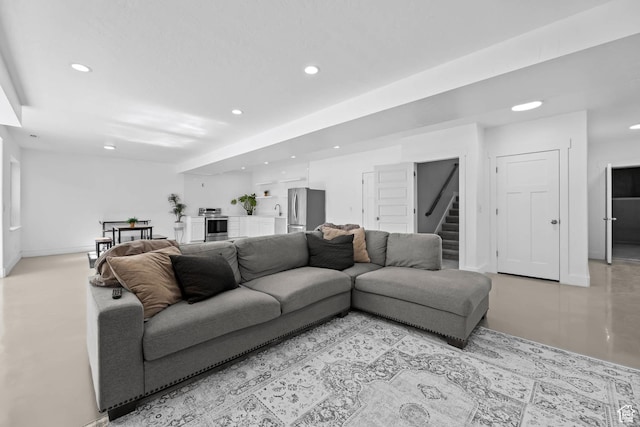 9447 N Arrowhead Dr, Eagle Mountain, UT 84005 - living area featuring stairway, recessed lighting, baseboards, and finished concrete floors