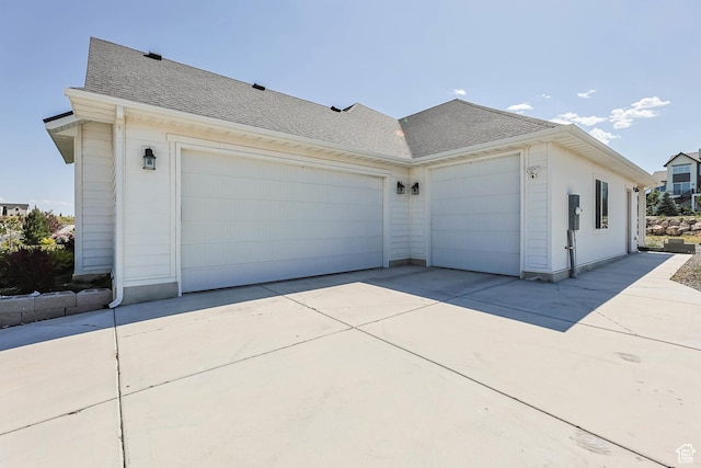 9447 N Arrowhead Dr, Eagle Mountain, UT 84005 - view of property exterior featuring roof with shingles, concrete driveway, and a garage