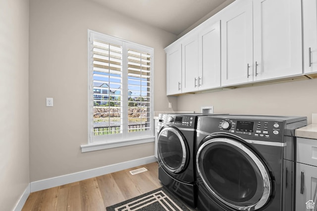 9447 N Arrowhead Dr, Eagle Mountain, UT 84005 - laundry room with cabinet space, independent washer and dryer, baseboards, and light wood finished floors