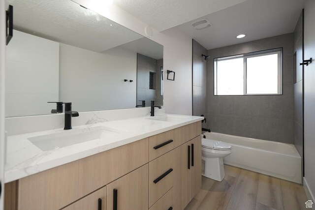 5866 N Fork Rd, Eden, UT 84310 - bathroom featuring wood finished floors, toilet, double vanity, and shower / washtub combination