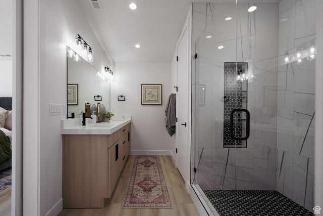 5866 N Fork Rd, Eden, UT 84310 - bathroom with vanity, a stall shower, baseboards, recessed lighting, and wood finished floors