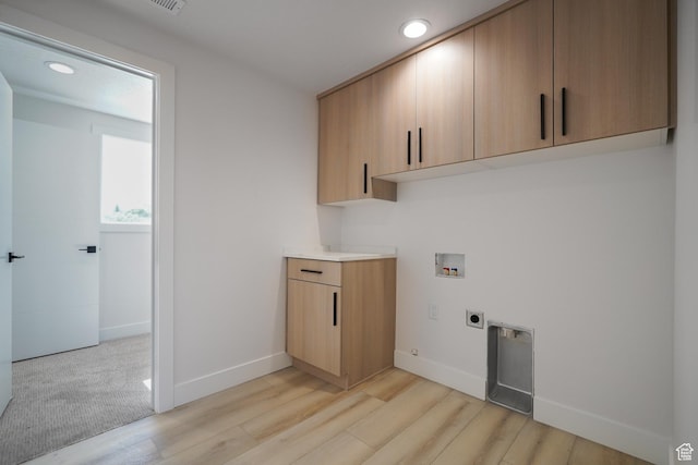 5866 N Fork Rd, Eden, UT 84310 - washroom with electric dryer hookup, washer hookup, cabinet space, light wood-style floors, and baseboards