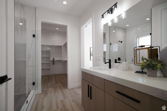 5866 N Fork Rd, Eden, UT 84310 - bathroom featuring a stall shower, vanity, a walk in closet, wood finished floors, and recessed lighting
