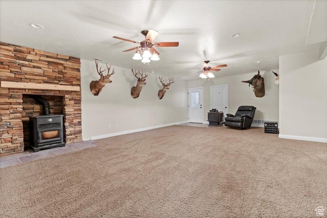 150 N 1015 W, Manti, UT 84642 - unfurnished living room with a ceiling fan, carpet, a wood stove, and baseboards