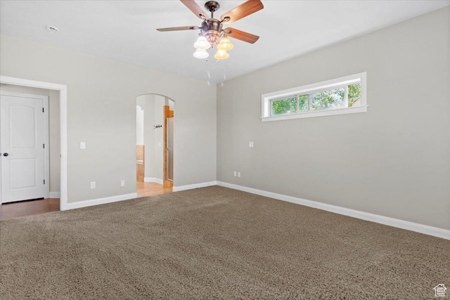 150 N 1015 W, Manti, UT 84642 - unfurnished bedroom featuring carpet floors, arched walkways, baseboards, connected bathroom, and a ceiling fan
