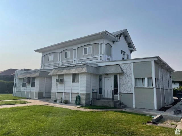 133 W Forest St, Brigham City, UT 84302 - view of front of property featuring brick siding, a front lawn, and cooling unit