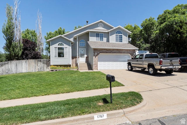 1767 E 2825 N, Layton, UT 84040 - view of front of house featuring a garage, driveway, and brick siding