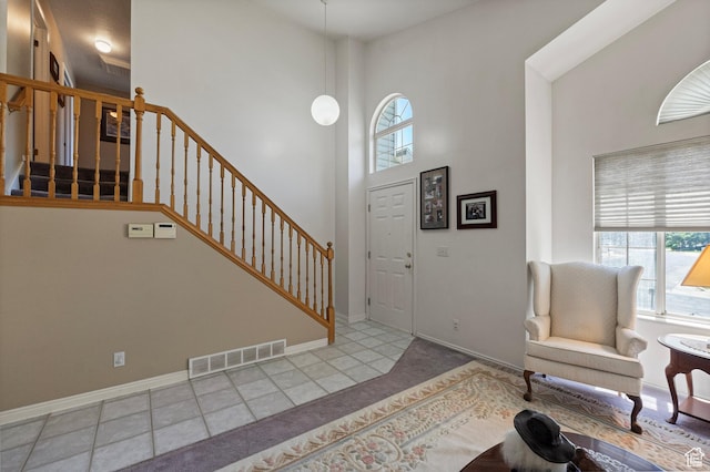 1767 E 2825 N, Layton, UT 84040 - entrance foyer with healthy amount of natural light, a towering ceiling, stairway, baseboards, and carpet flooring