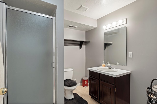 1767 E 2825 N, Layton, UT 84040 - full bath with toilet, vanity, a shower stall, a textured ceiling, and tile patterned floors