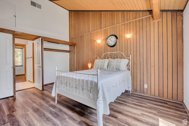 1063 Oxford Dr, Ogden, UT 84403 - bedroom with wooden walls, wood ceiling, wood finished floors, and a closet