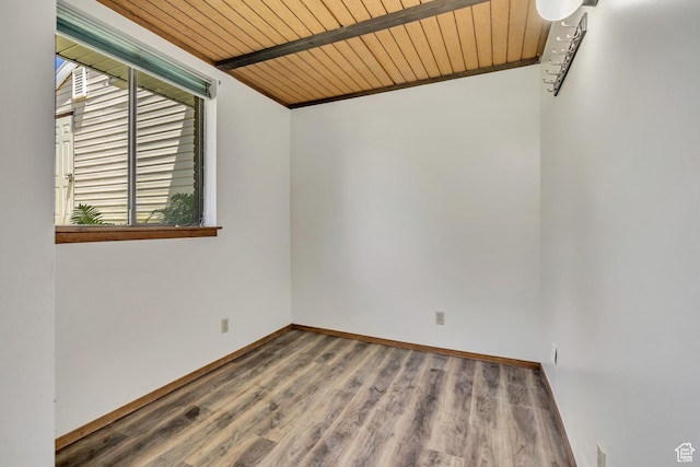 1063 Oxford Dr, Ogden, UT 84403 - empty room featuring wooden ceiling with exposed beams, wood finished floors, and baseboards