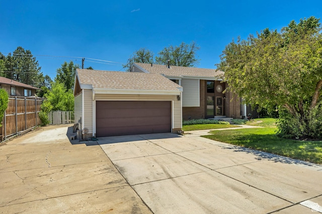 1063 Oxford Dr, Ogden, UT 84403 - view of front of house featuring concrete driveway, an attached garage, and roof with shingles