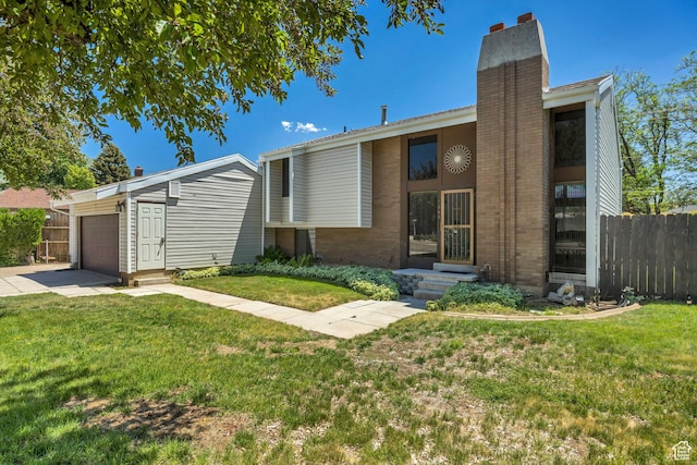 1063 Oxford Dr, Ogden, UT 84403 - view of front facade with a chimney, a garage, brick siding, driveway, and an outbuilding