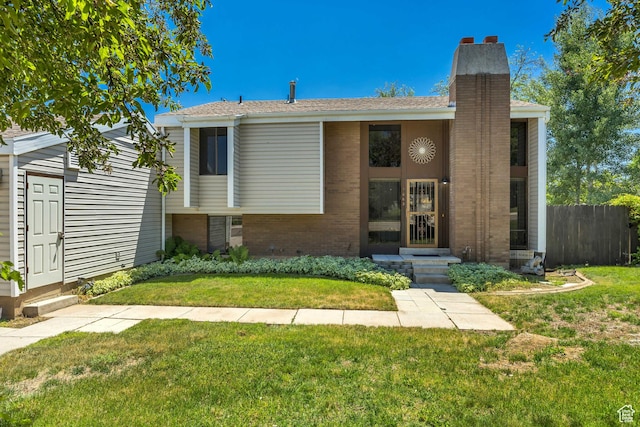 1063 Oxford Dr, Ogden, UT 84403 - view of front facade with a chimney and brick siding