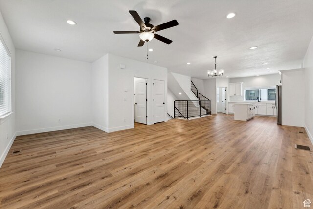 622 E 340 S, American Fork, UT 84003 - unfurnished living room featuring recessed lighting, a chandelier, ceiling fan, light wood-style flooring, and stairs