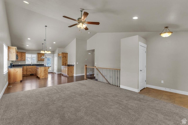 1848 W 645 S, Orem, UT 84059 - unfurnished living room with lofted ceiling, ceiling fan, baseboards, dark colored carpet, and recessed lighting