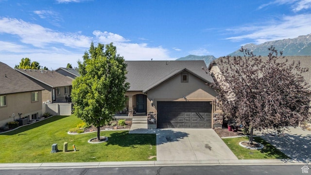 1848 W 645 S, Orem, UT 84059 - view of front of house featuring a garage, driveway, a front yard, a mountain view, and central air condition unit